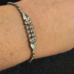 Vintage silver tone and rhinestone bracelet includes two pair shaped rhinestones